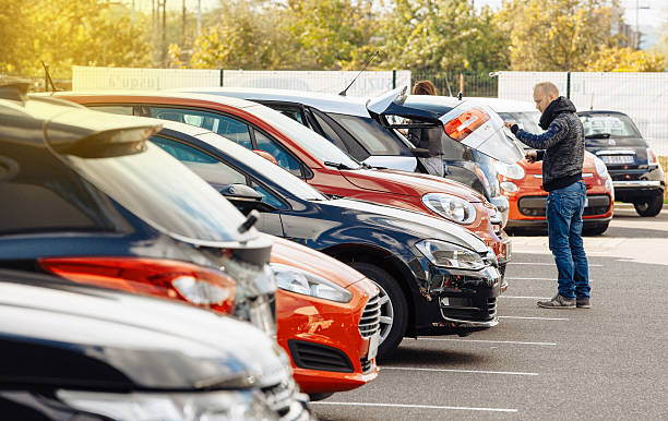 Street view of man choosing new car